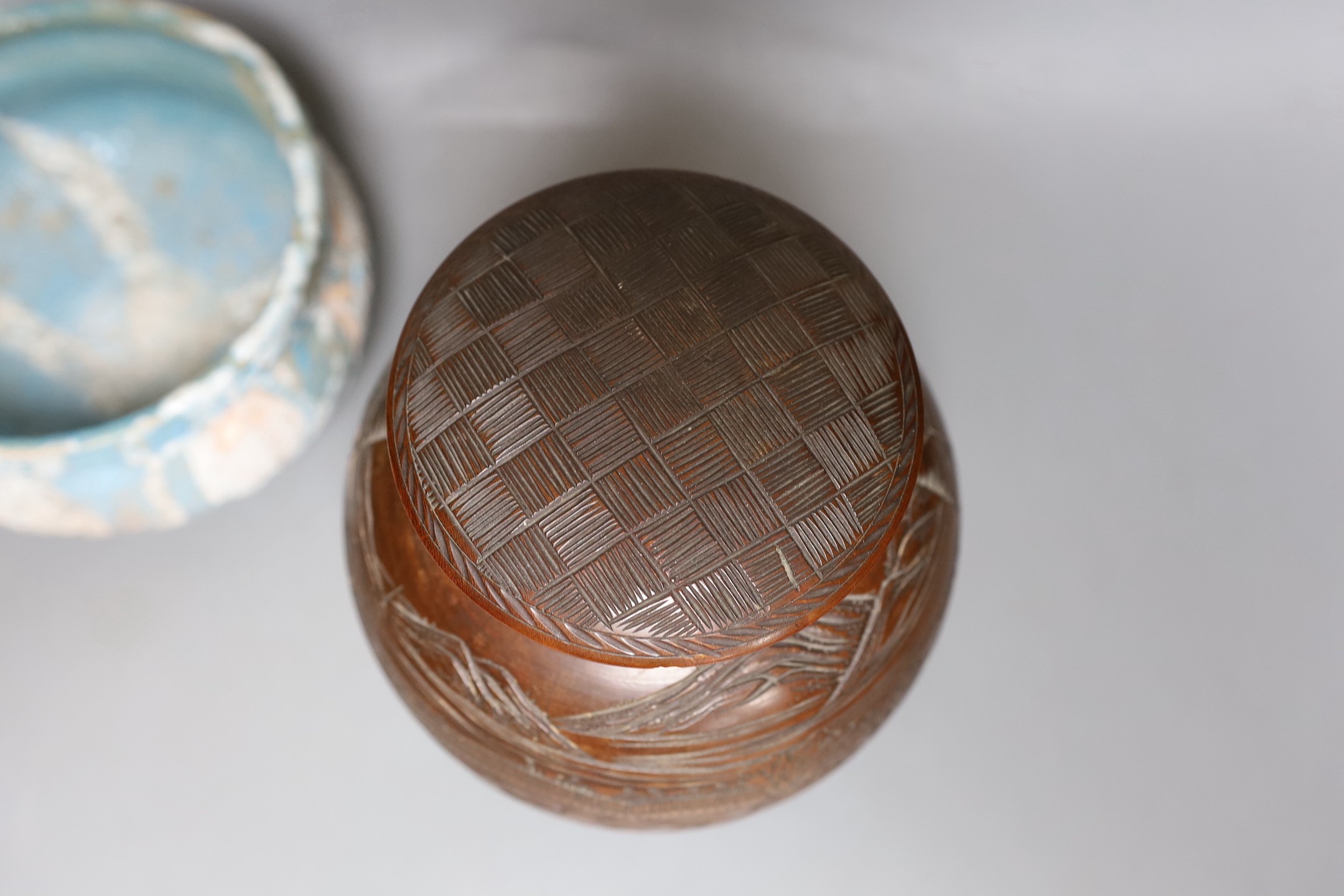 Two Japanese stoneware tea bowls (chawan), a Japanese raku bowl and a Japanese carved wood tea caddy, 19cm